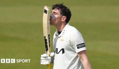 Surrey's Dan Lawrence kisses his bat after reaching a century against Essex at the Oval