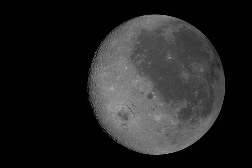 This image provided by NASA Monday, April 6, 2026, shows the Moon, the near side (the hemisphere we see from Earth) visible at the right side of the disk.