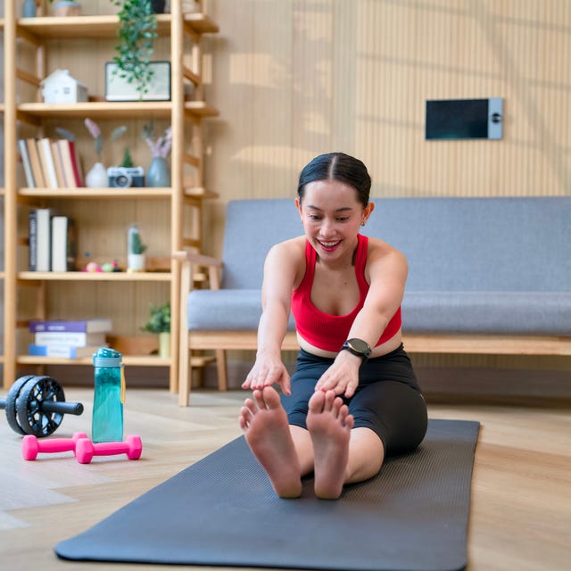 Young adult woman stretching exercising yoga at home Young adult woman stretching exercising yoga at home
