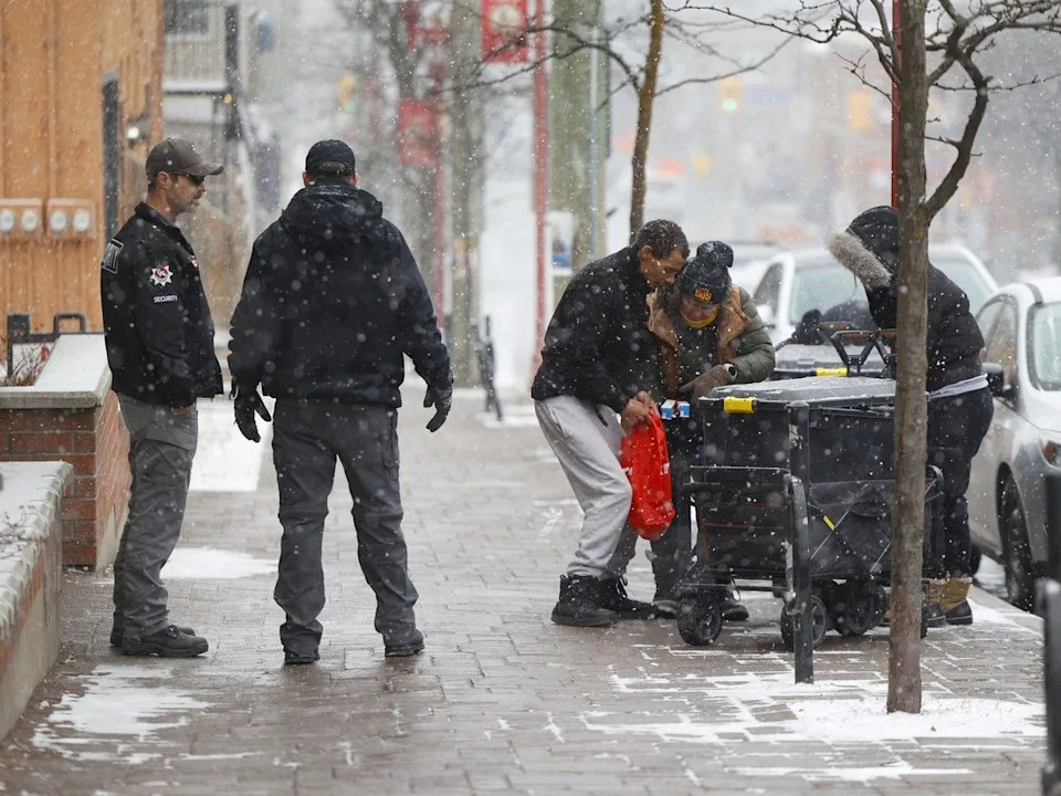 Security stands outside a clinic on Somerset Street in Ottawa in early April.