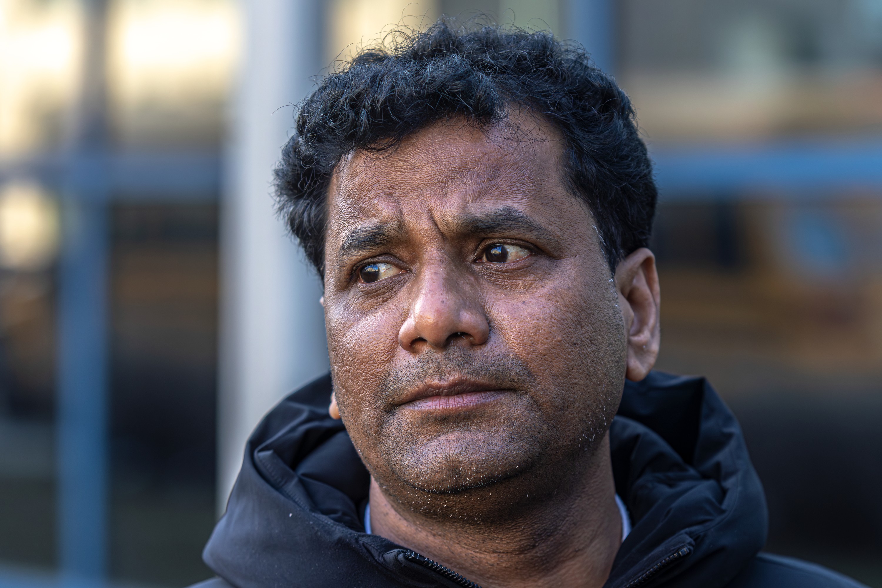 Profile of a man with a serious face, looking slightly downwards.