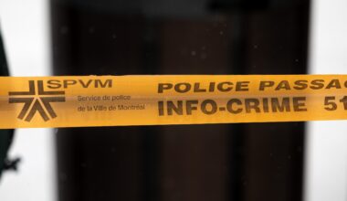 Montreal police tape blocks access to a street in Montreal, on Sunday, March 22, 2026.