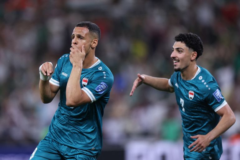 Iraq's forward #09 Ali Al-Hamadi (L) celebrates scoring his team's first goal.