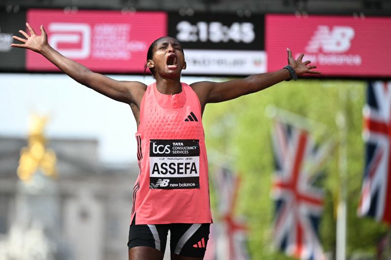 Ethiopia's Tigst Assefa reacts after crossing the line to win the women's race in a new women's only world record at the 2026 London Marathon in central London on April 26, 2026. (Photo by JUSTIN TALLIS / AFP) / Restricted to editorial use - sponsorship of content subject to LMEL agreement.