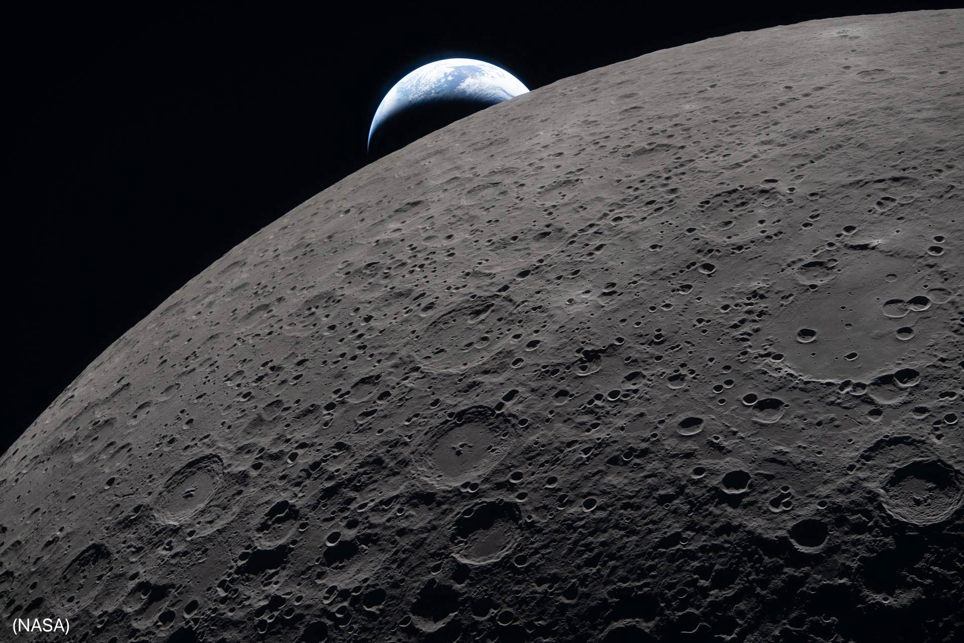 Earth setting behind lunar surface (NASA)