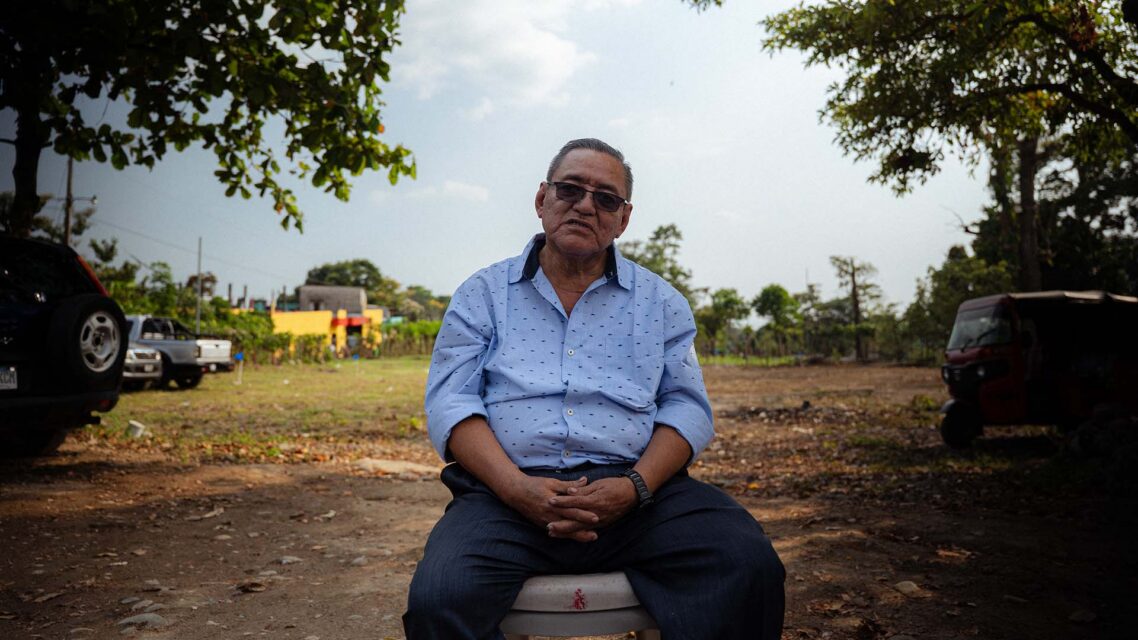 Alberto Xum sitting on a chair outside.