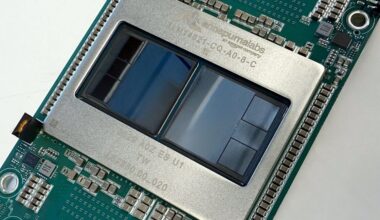 An angled, top-down view of Amazon's Trainium3 chip that is designed to train larger AI models and serve more customers using AI services.
