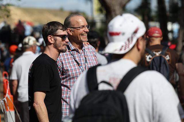 NASCAR legend Kyle Petty, cenrer, poses for a photo with a fan as people exit the Rockingham Special for race day at Rockingham Speedway on Saturday, April, 4, 2026.