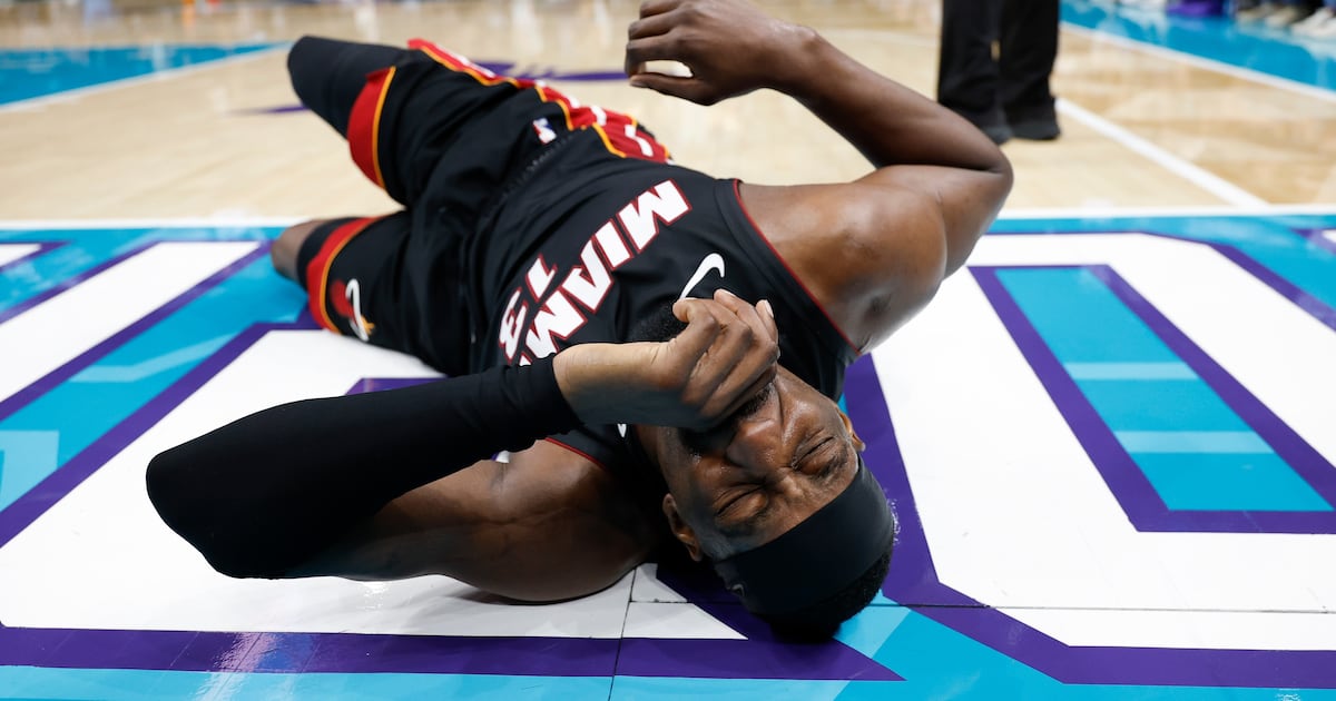 Heat's Bam Adebayo taken to locker room after LaMelo Ball trips him, leading to hard fall