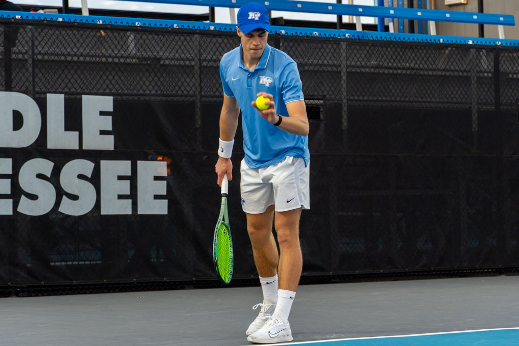 Jonasz Dziopak prepares to serve at the MTSU outdoor tennis complex on Feb. 20, 2026.