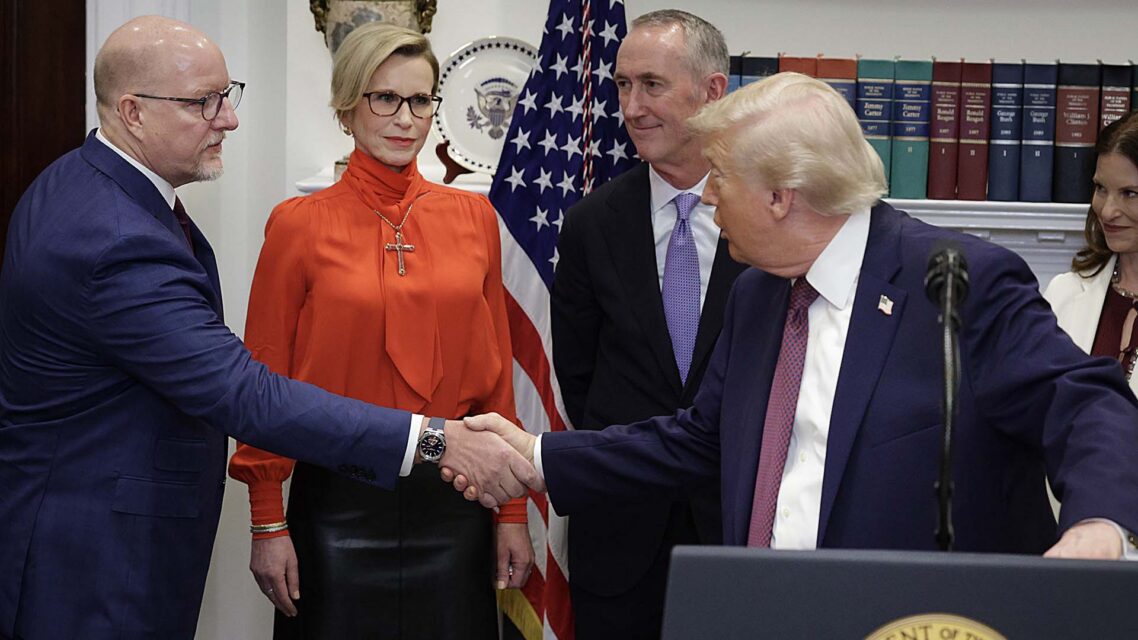 Photo of Merck CEO Robert Davis shaking hands with US President Donald Trump, as other pharma execs look on.