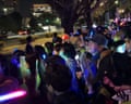 Demonstrators in Tokyo wave lightsabers during evening protest 