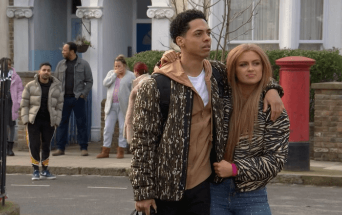 EastEnders Keegan and Tiffany exit Zack Morris as Keegan Butcher-Baker and Maisie Smith as Tiffany Butcher-Baker stand in the street in EastEnders.