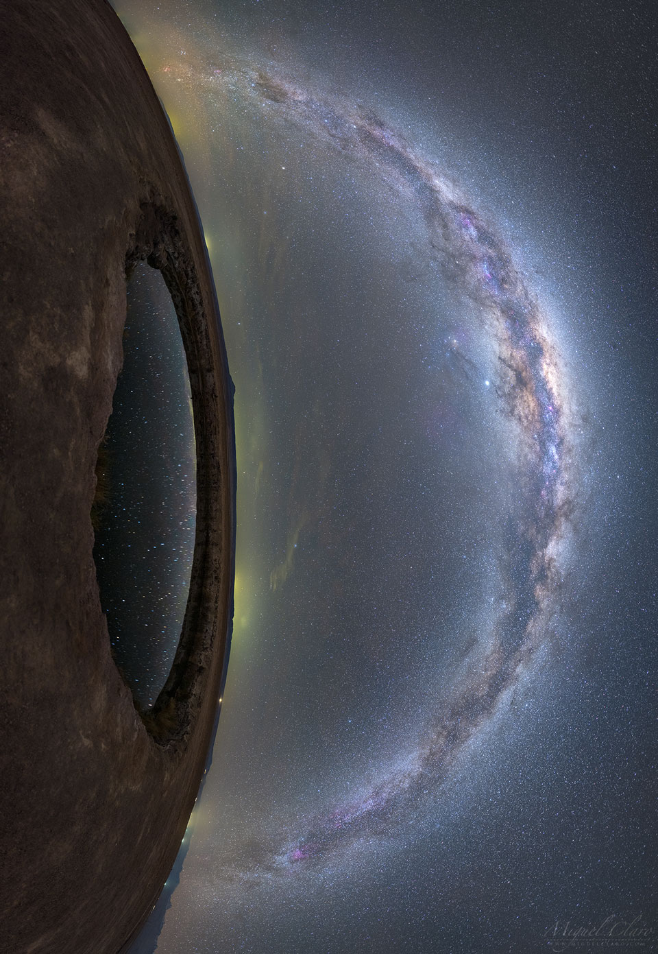 The image shows land on the left and a star filled
sky on the right. Prominent in the sky is the band of our
Milky Way Galaxy. On the left is a small circular lake
that reflects some of the stars in the sky. Together,
the land and lake look like an eye lookout out at the
Milky Way.
Please see the explanation for more detailed information.