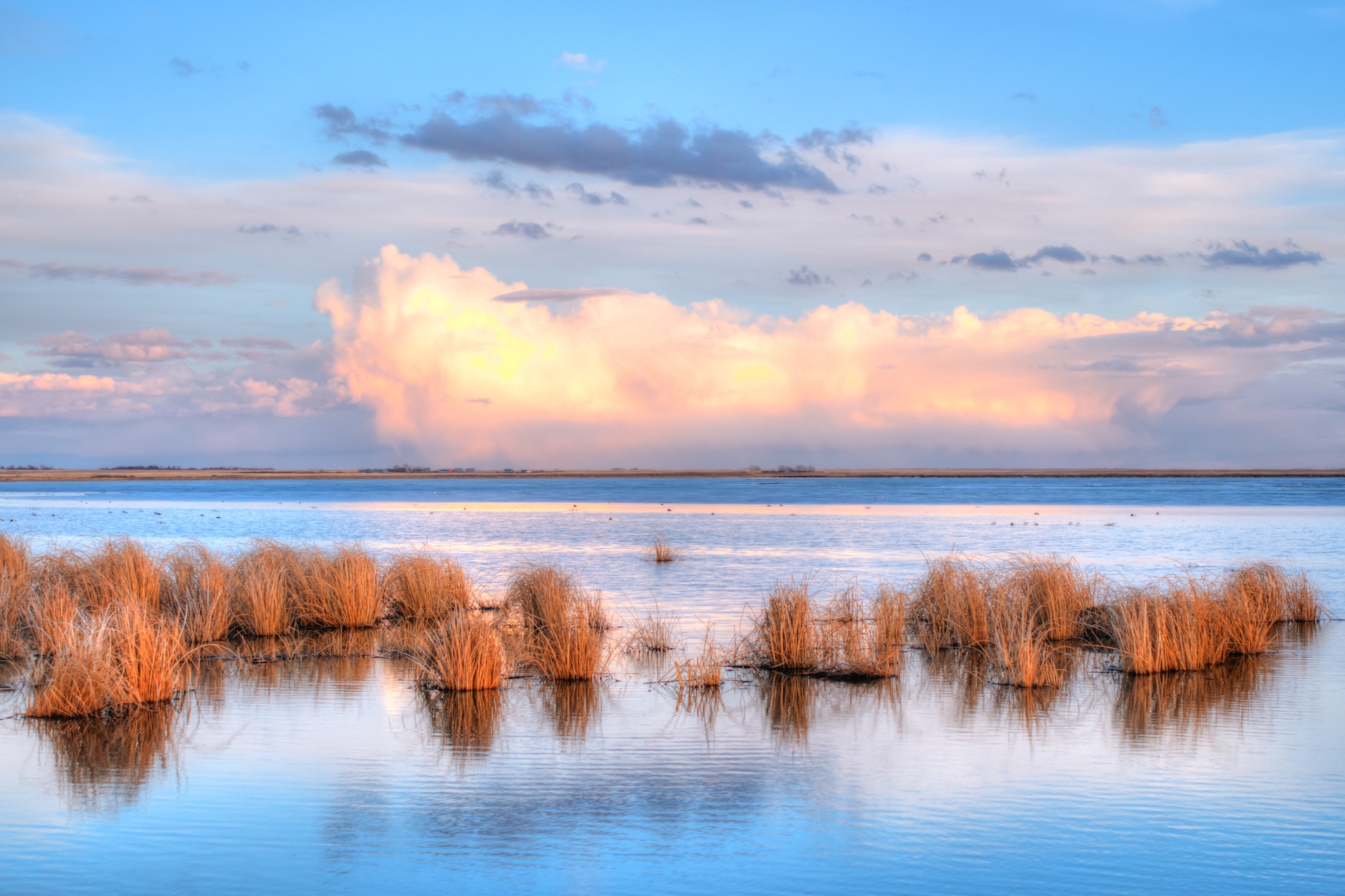 Clouds over wetlands at Sunset, Frank Lake Alberta Canada