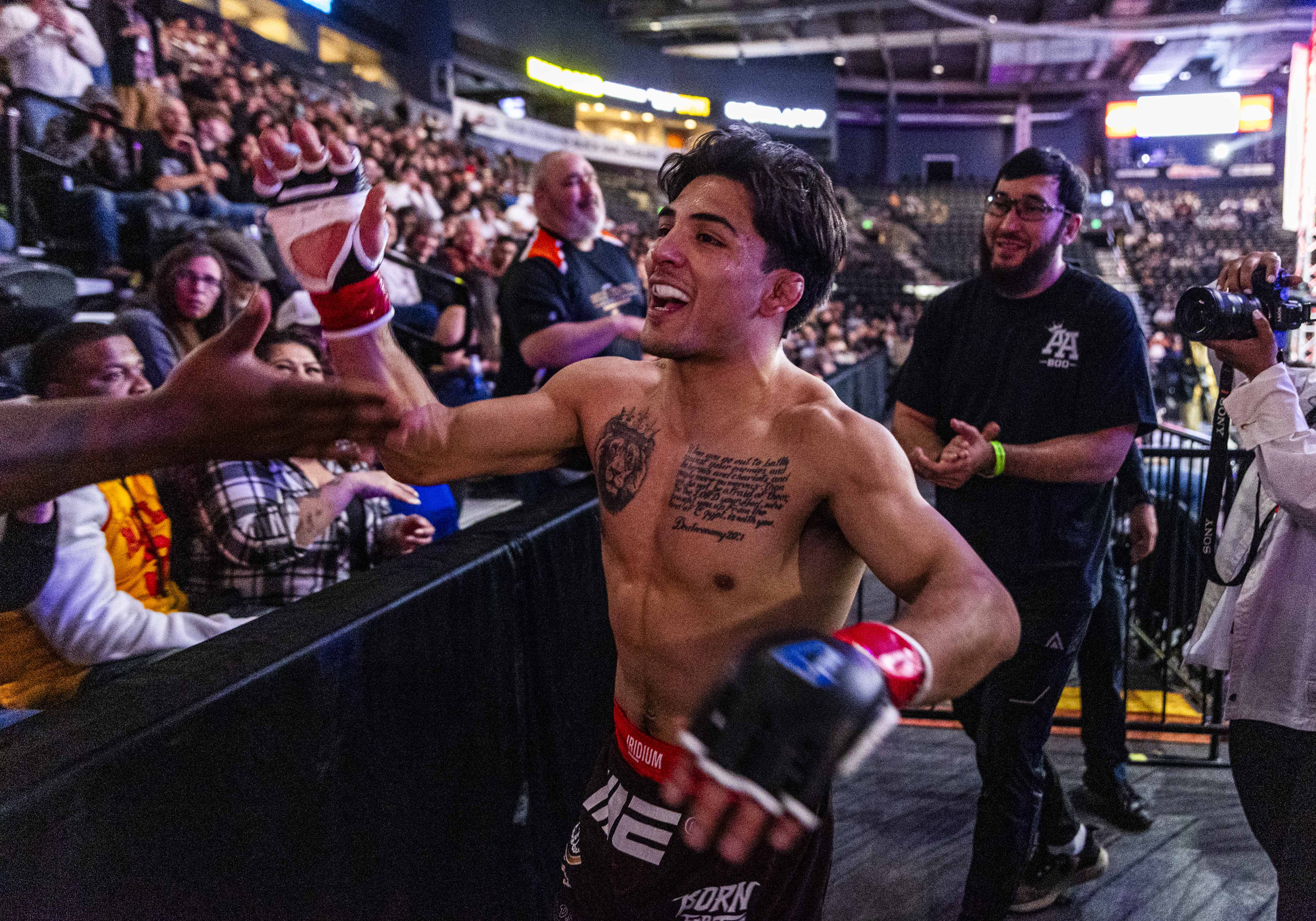 Andrew Alirez celebrates with fans in the audience as he...