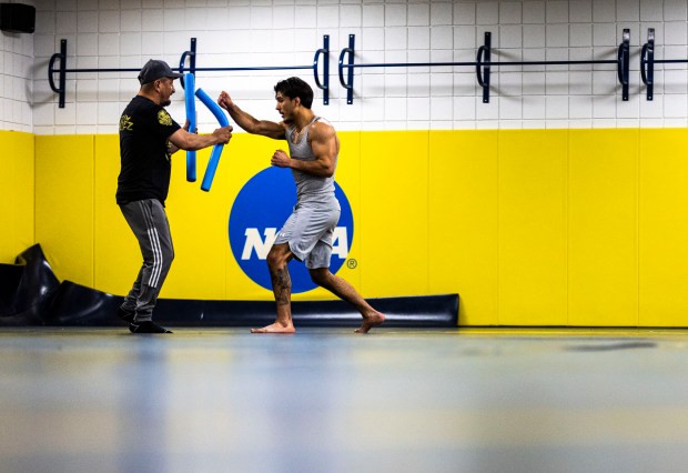 Andrew Alirez, right, practices for his upcoming MMA fight with his uncle, a former MMA fighter, Mike Alirez, left, in the wrestling room in the Butler-Hancock Athletics Center on the campus of the University of Northern Colorado in Greeley on Friday, March 20, 2026. (Brice Tucker/Staff Photographer)