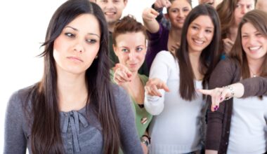 Crowd pointing fingers at a young woman