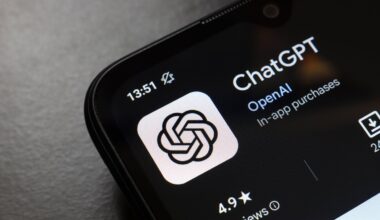 The ChatGPT app logo displays on the screen of a smartphone