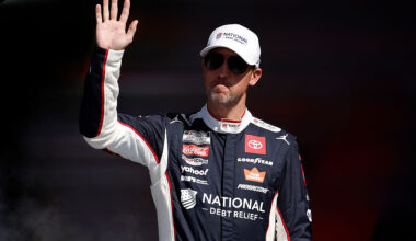 TALLADEGA, ALABAMA - OCTOBER 19: Denny Hamlin, driver of the #11 National Debt Relief Toyota, waves to fans as he walks onstage during driver intros prior to the NASCAR Cup Series YellaWood 500 at Talladega Superspeedway on October 19, 2025 in Talladega, Alabama.