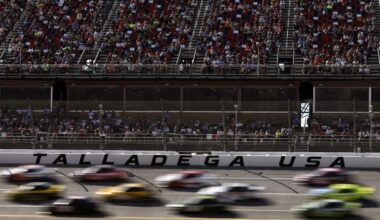Cars race past the grandstands at Talladega Superspeedway during a NASCAR Cup Series event