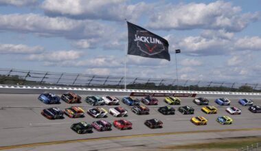 NASCAR Cup Series cars race in a tight pack at Talladega Superspeedway beneath a Jack Link’s 500 banner