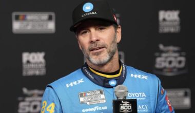 Jimmie Johnson speaks during Daytona 500 Media Day in 2026 wearing No. 84 Legacy Motor Club uniform