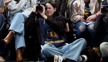 INDIANAPOLIS, INDIANA - MARCH 25: Caitlin Clark of the Indiana Fever sits on the baseline and makes photographs during the Indiana Pacers game against the Los Angeles Lakers at Gainbridge Fieldhouse on March 25, 2026 in Indianapolis, Indiana.