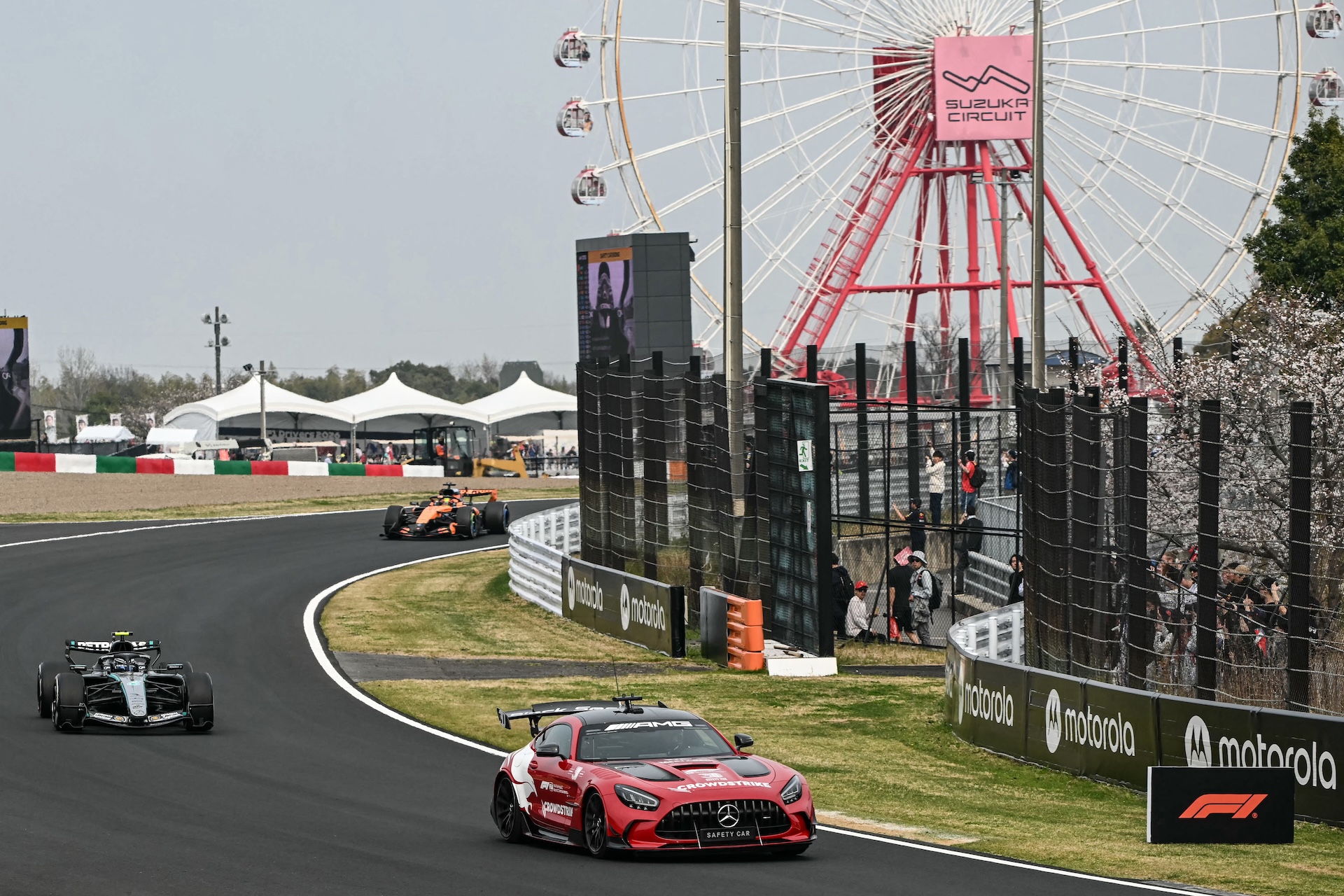 The safety car leads drivers following a crash by Haas F1 Team's British driver Oliver Bearman during the Formula One Japanese Grand Prix at the Suzuka circuit in Suzuka, Mie prefecture on March 29, 2026. (Photo by Toshifumi KITAMURA / AFP)