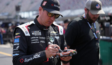 BRISTOL, TENNESSEE - APRIL 11: Kyle Busch, driver of the #8 BankOZK Chevrolet, signs an autograph for a NASCAR fans during practice for the NASCAR Cup Series Food City 500 at Bristol Motor Speedway on April 11, 2026 in Bristol, Tennessee. (Photo by Matt Kelley/Getty Images)