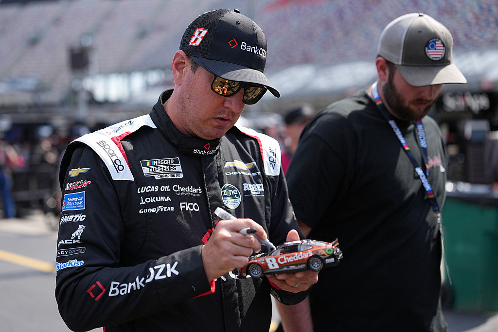 BRISTOL, TENNESSEE - APRIL 11: Kyle Busch, driver of the #8 BankOZK Chevrolet, signs an autograph for a NASCAR fans during practice for the NASCAR Cup Series Food City 500 at Bristol Motor Speedway on April 11, 2026 in Bristol, Tennessee. (Photo by Matt Kelley/Getty Images)