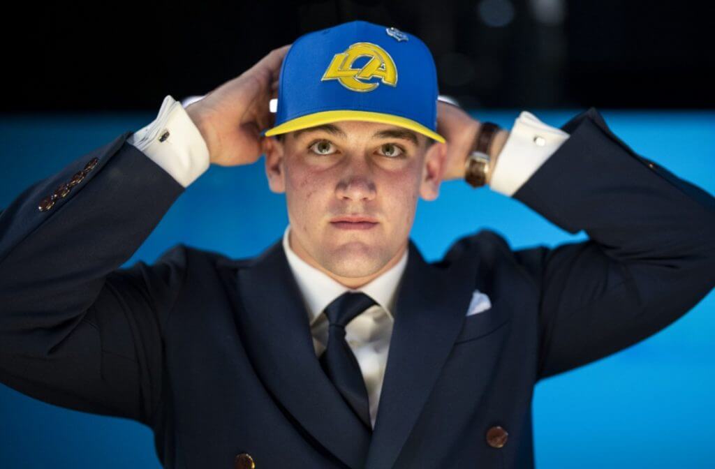 Ty Simpson puts on a Rams hat after being drafted by the franchise in the first round.