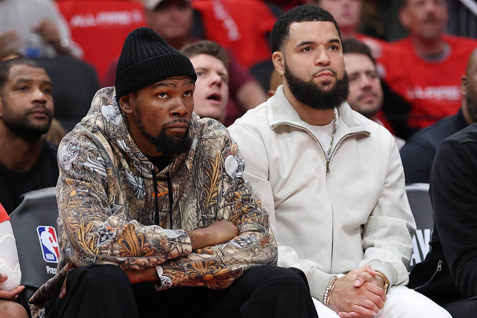 Kevin Durant looks on from the bench during a Rockets game