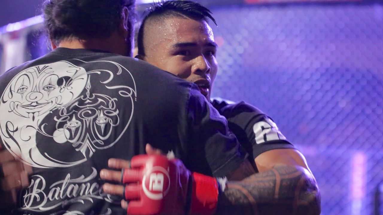 Kai Kamaka III hugged a friend after a Bellator MMA fight at the Blaisdell Arena in 2023.