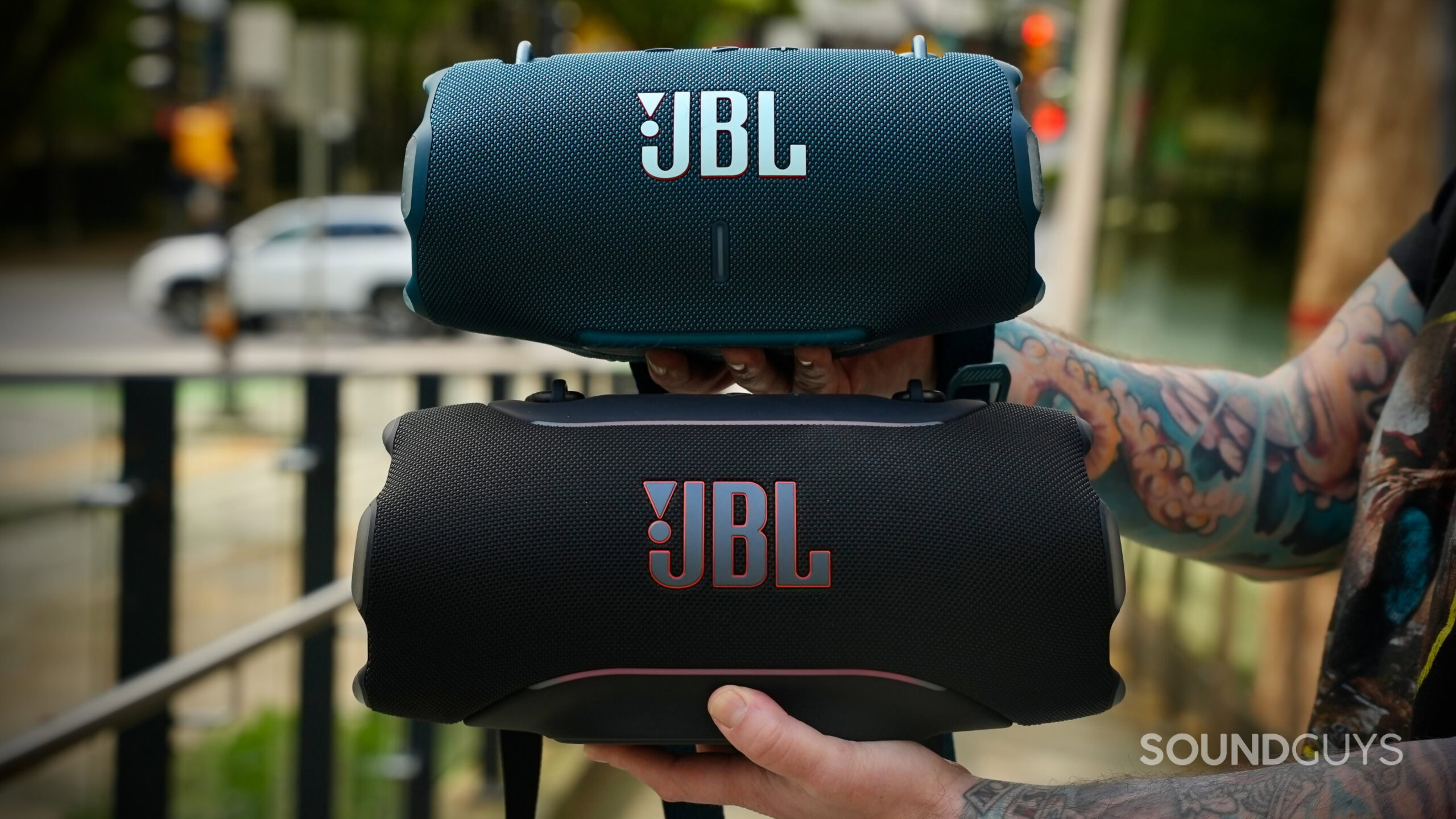 JBL Xtreme 5 vs Xtreme 4 - 3 The JBL Xtreme 5 and JBL Xtreme 4 stacked, highlighting the front grilles and JBL logos.