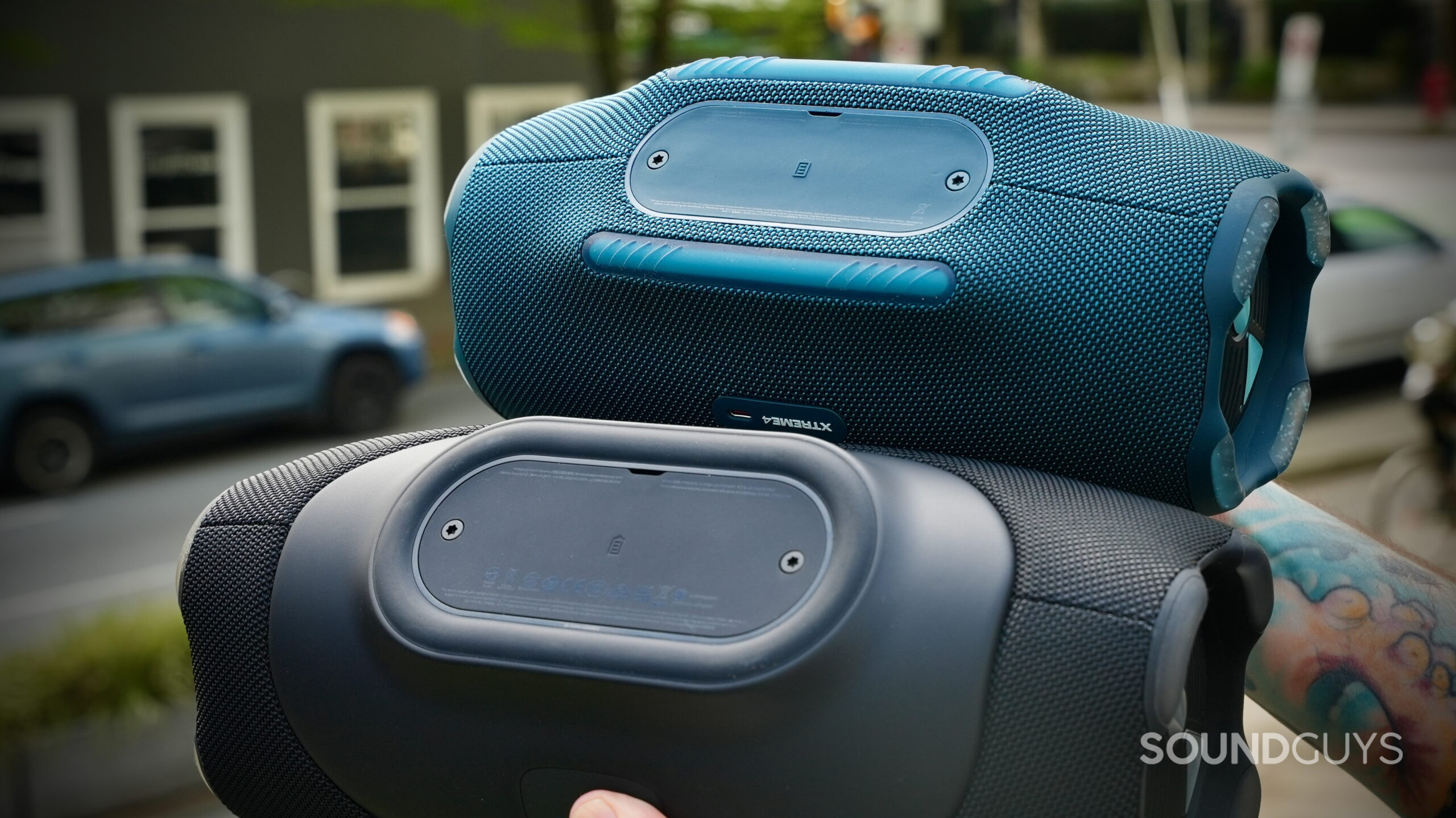 Close-up of the underside of the JBL Xtreme 5 and JBL Xtreme 4 showing base plates and rubber feet.