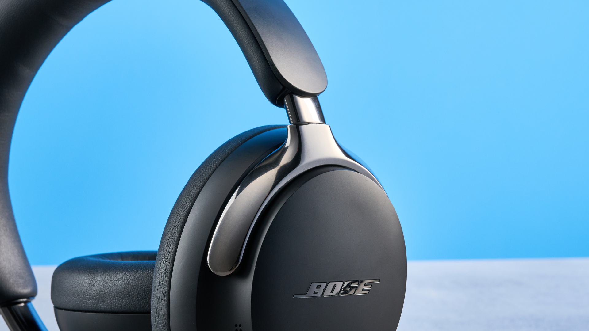 the bose quietcomfort ultra gen 2 headphones in black photographed on a blue tom's guide background