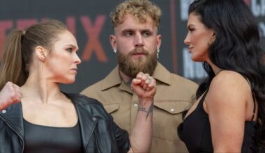 Ronda Rousey and Gina Carano facing off in front of Jake Paul