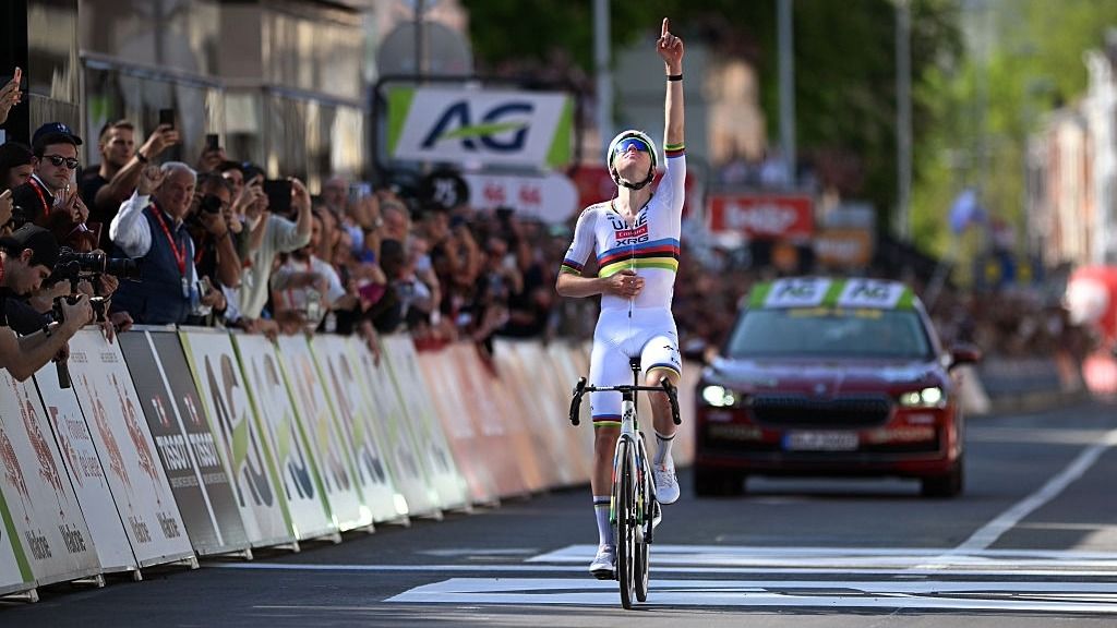 Tadej Pogacar points to the sky after crossing the line first to win the Liege-Bastogne-Liege 2025 cycling Monument.