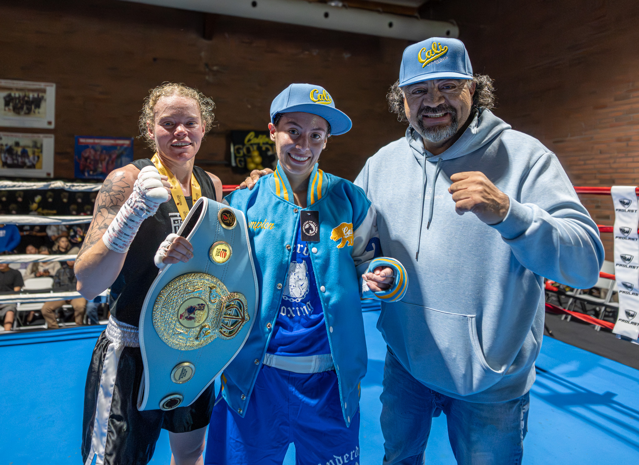 Shavana Trejo holds her championship belt alongside her opponent, Davin...