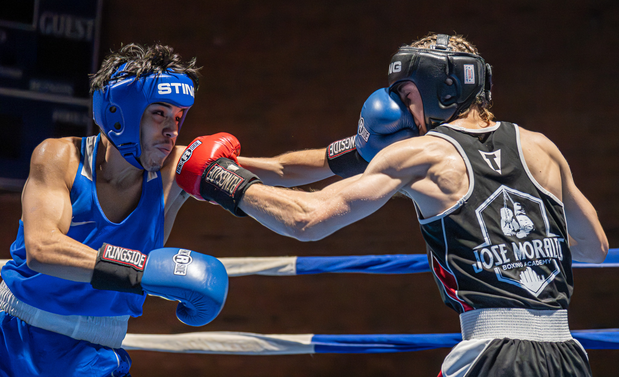 Boxers spar during the third round of a California State...