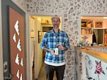Sean Lanusse holds a bottle of Bactine MAX, an over-the-counter anesthetic that many tattoo artists use, in Thunderbird Tattoo, the tattoo shop where he works in the St. Johns neighborhood of Portland. April 1, 2026.