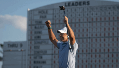 Rory McIlroy puts both fists up in the air while holding his putter after winning The Masters in 2026