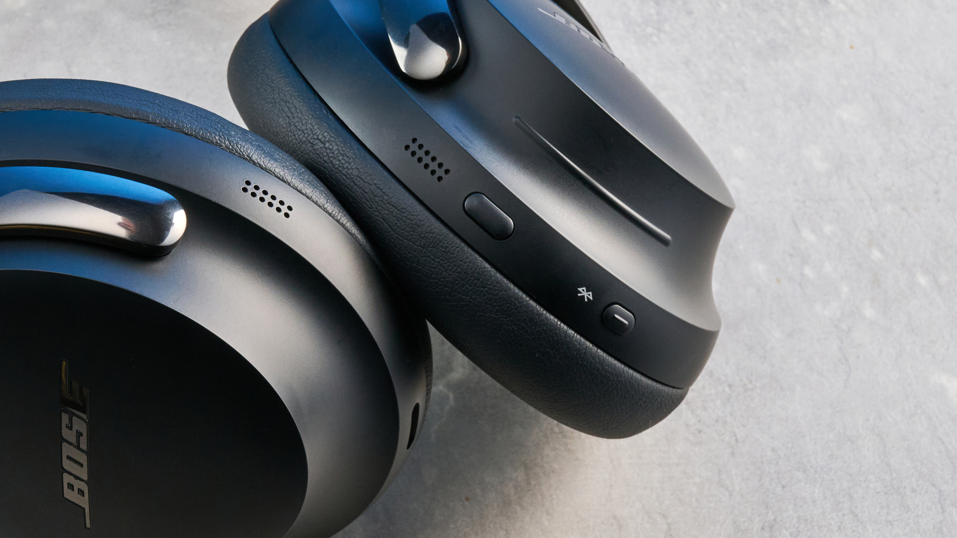 the bose quietcomfort ultra gen 2 headphones in black photographed on a blue tom's guide background