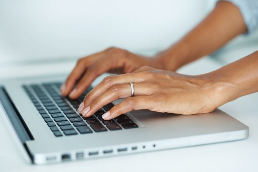 5 Things I Wish I Knew About Money in My 30s - 3 A woman's hands typing on a laptop keyboard.