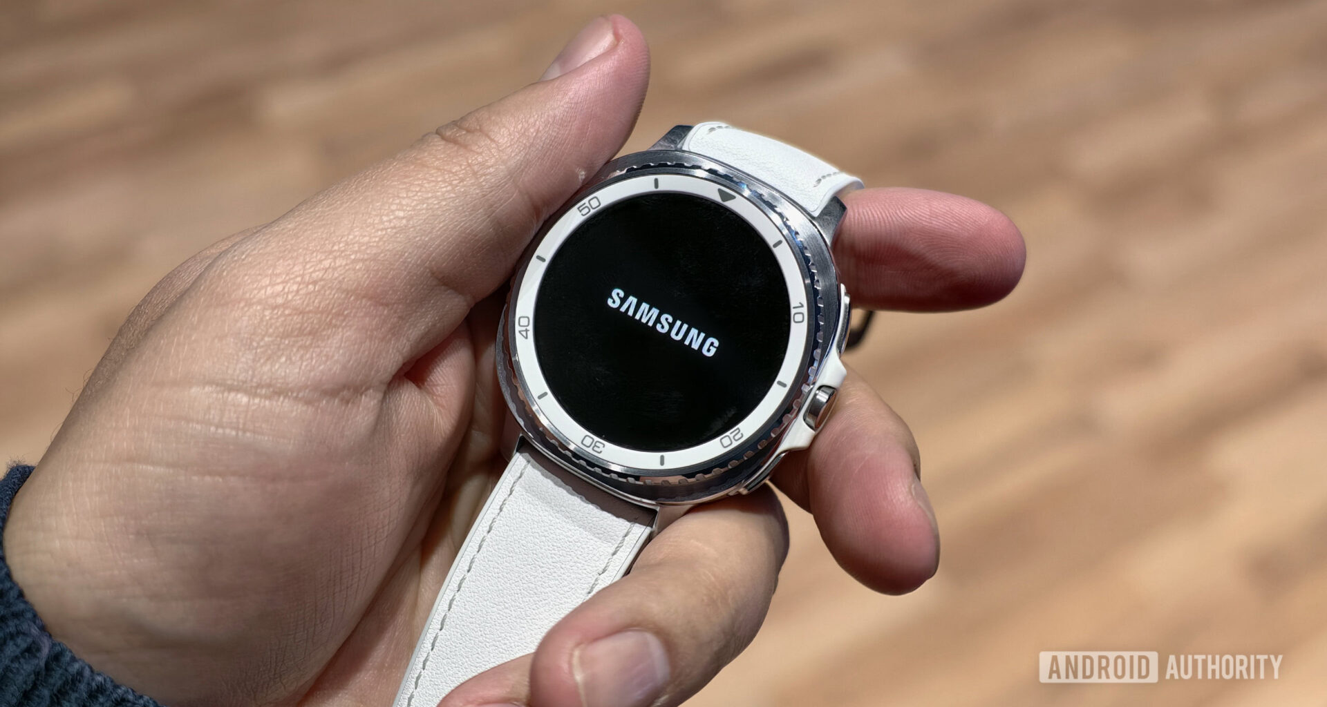 Samsung Galaxy Watch Classic in hand with Samsung logo
