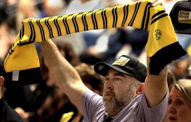 Displaying the colors of Borussia Dortmund, a German soccer club, Justin Selander pays tribute to Marcus Ziemer during a public memorial for Ziemer, Saturday, April 18, 2026, at Sonoma State University. (Kent Porter / The Press Democrat)