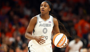 Las Vegas Aces guard Jackie Young dribbles the ball.