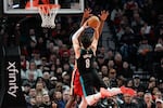 Portland Trail Blazers forward Deni Avdija (8) goes to the basket as Portland Trail Blazers new owner Tom Dundon, second from right, watches during the first half of an NBA basketball game against the New Orleans Pelicans, Thursday, April 2, 2026, in Portland, Ore.