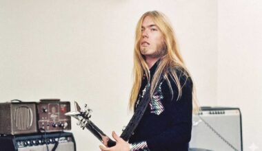 Greg Allman playing guitar, surrounded by amps